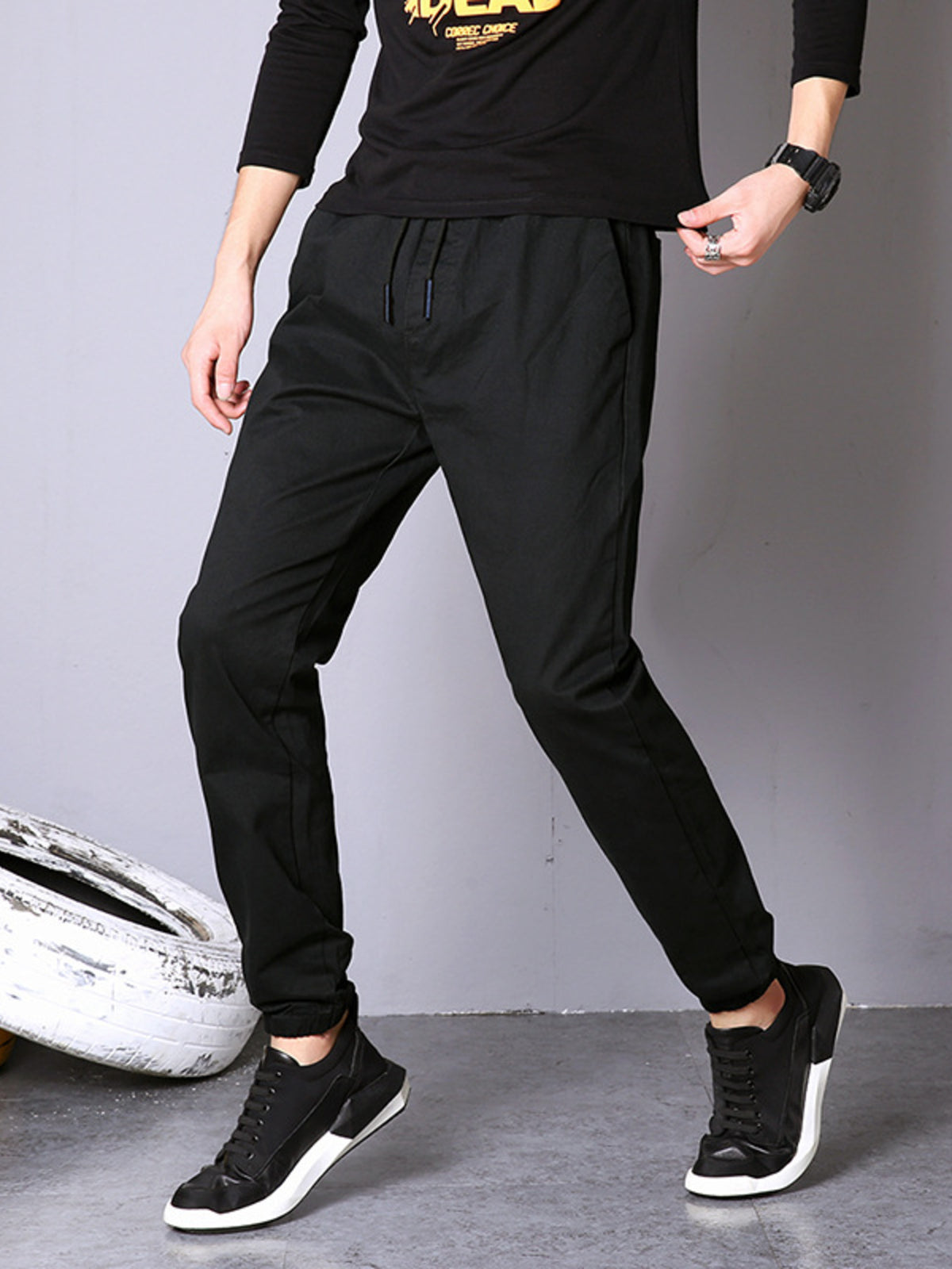 Black casual pants with drawstring waist and cuffed ankles