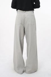 Gray wide-leg denim jeans with sculpted volume and back pockets.