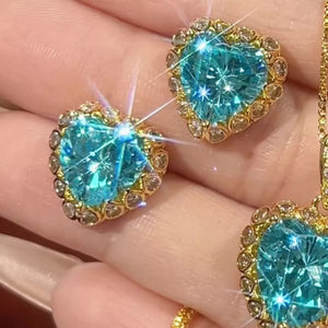 gold earrings featuring heart-shaped and heart