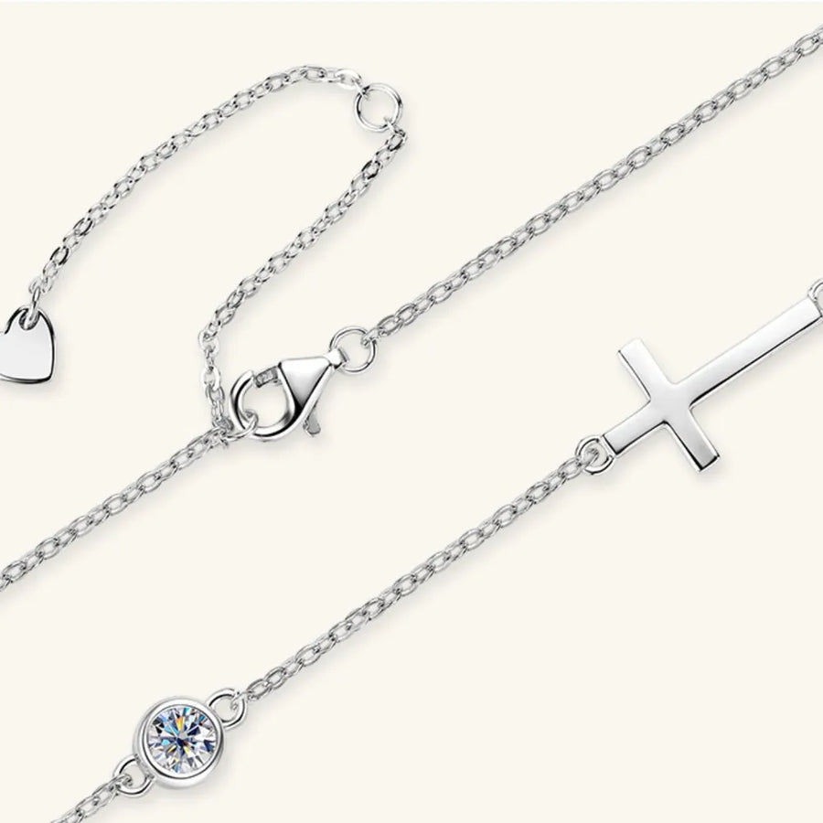 Silver asymmetrical cross pendant necklace with cubic zirconia and heart charm