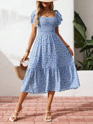 Blue floral smocked ruffle sleeve midi dress with tiered skirt and square neckline.