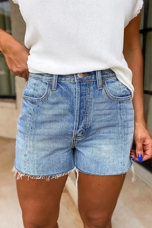 High-waisted denim shorts in light blue wash with frayed hem and distressed details.