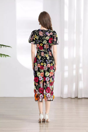 Black floral embroidered midi dress with short flutter sleeves and a sheer hem.
