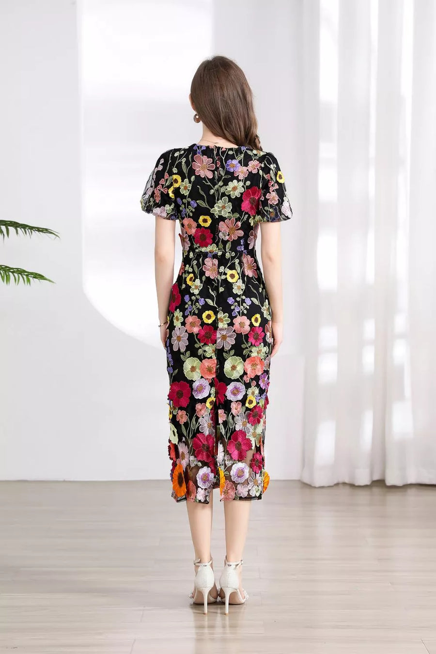 Black floral embroidered midi dress with short flutter sleeves and a sheer hem.