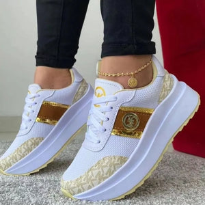 White round toe platform sneakers with gold logo detail and monogram pattern.