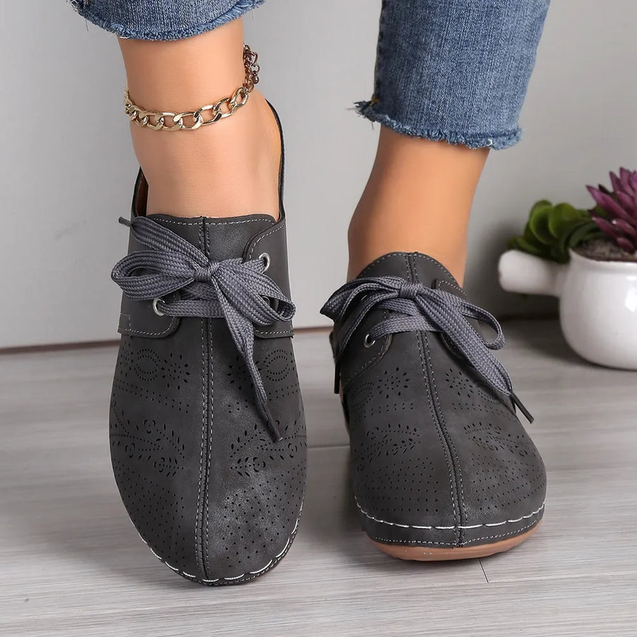 Dark Gray perforated lace-up mule flats with decorative stitching and tie closure.