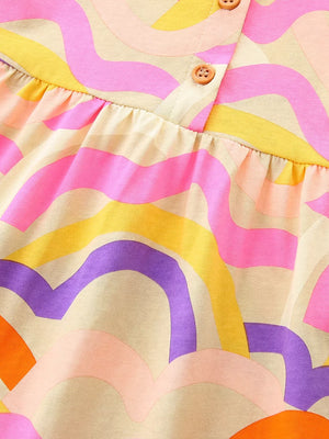 Toddler dress with abstract waves print in pink, yellow, purple, and orange on a cream cotton blend.