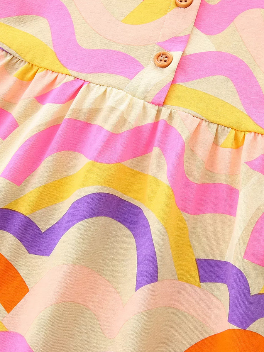 Toddler dress with abstract waves print in pink, yellow, purple, and orange on a cream cotton blend.