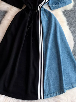 Color block casual dress with drawstring, black and denim panels, and white stripe detail.
