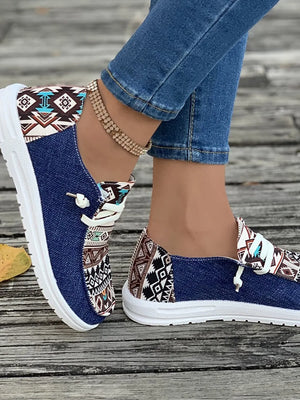 Aztec print canvas slip-on shoes in light indigo with white laces and soles.