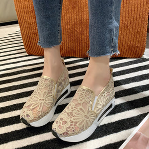 Khaki lace mesh slip-on flats with white soles and gold trim.