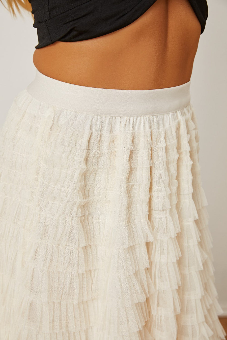 Tiered tulle maxi skirt in ivory with ruffled layers and a comfortable elastic waistband.