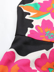 Vibrant floral midi dress with spaghetti straps in black with pink, orange, and green flowers.