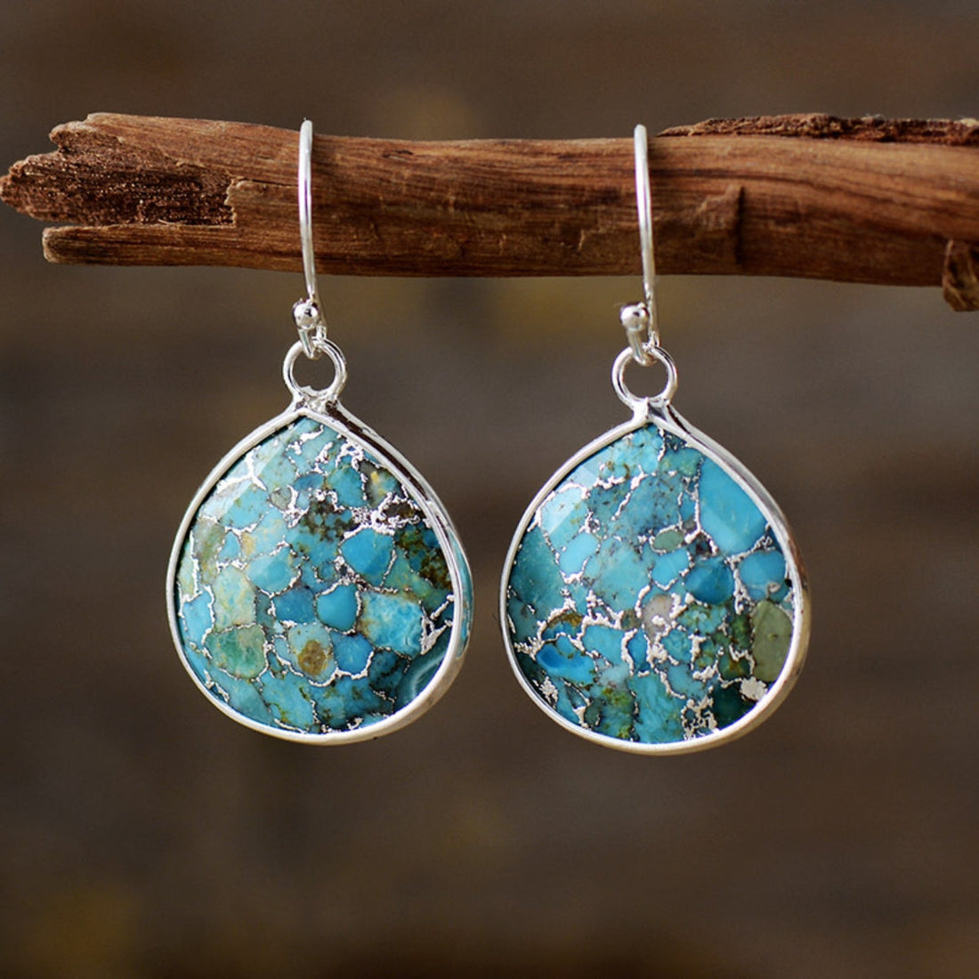 Turquoise matrix teardrop earrings with silver setting.