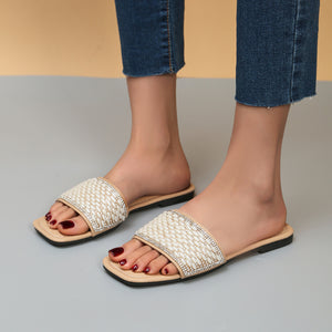 Chic open toe slide sandals with pearl and rhinestone embellished strap.