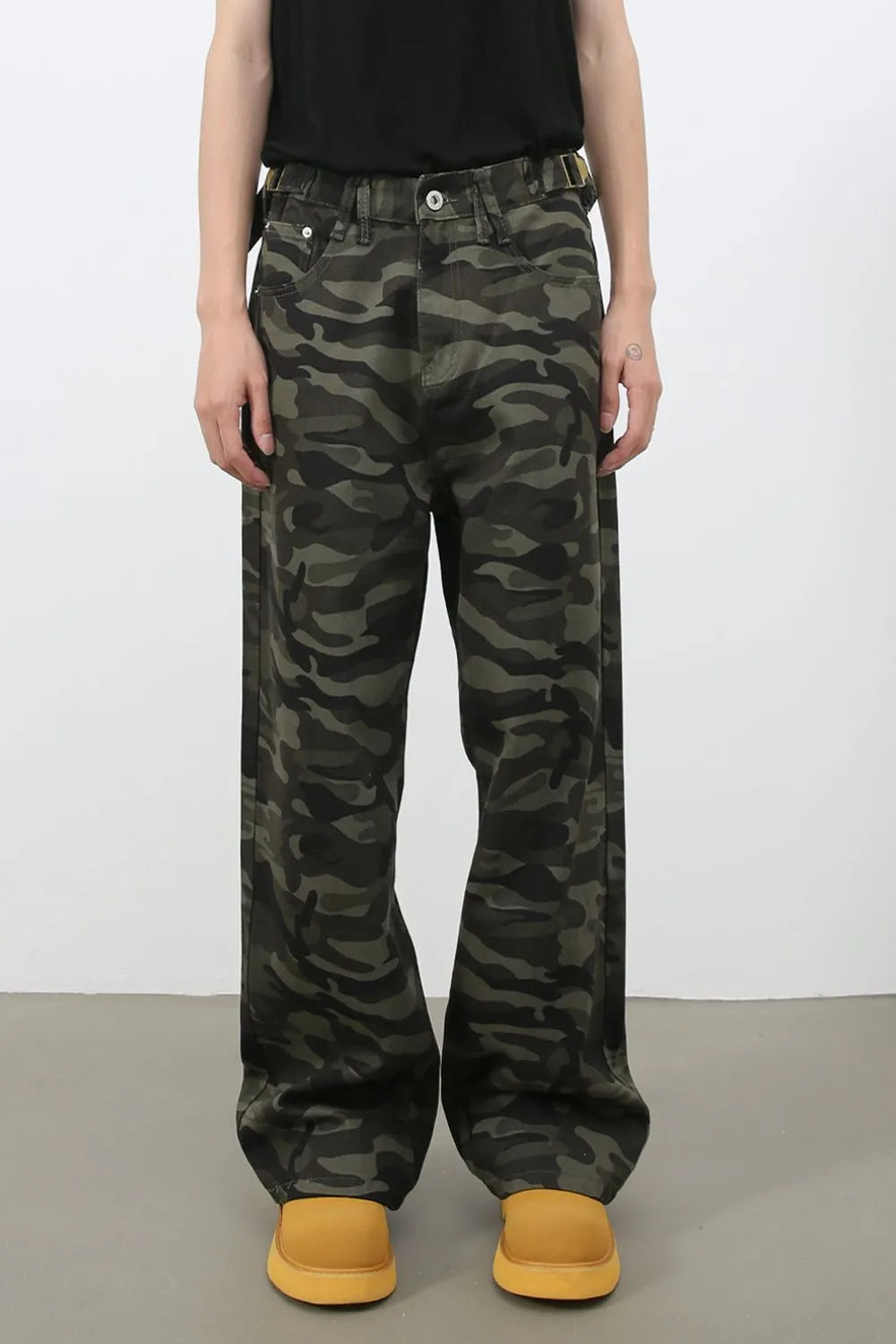 Wide-leg camo denim trousers in black with a relaxed fit.