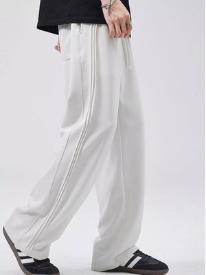 Relaxed fit joggers in light gray with triple stripe detail on the leg.