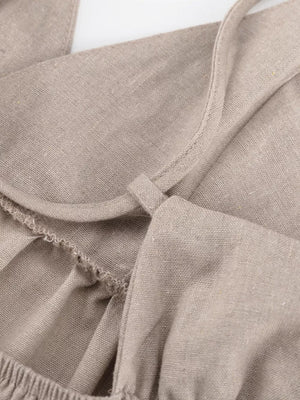 Linen camisole in beige with adjustable straps and ruffled detail.