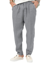 Gray linen drawstring relaxed fit trousers with adjustable waist and pockets.