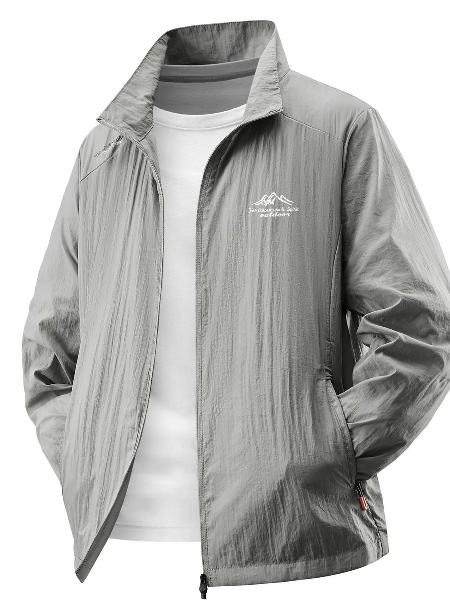 Lightweight windbreaker jacket in light gray with a zip front and embroidered mountain logo.