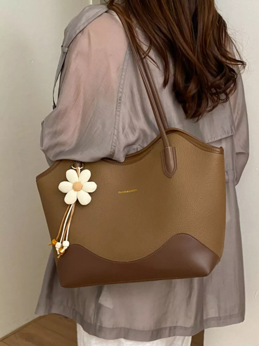 Black handbag with flower charm and null