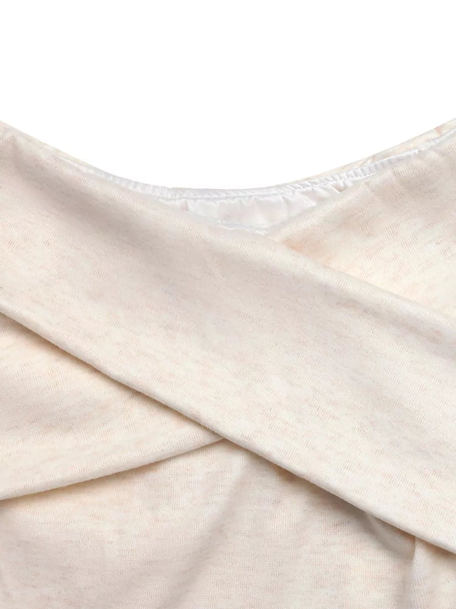 Cream marled knit top with crossover detail and satin trim neckline