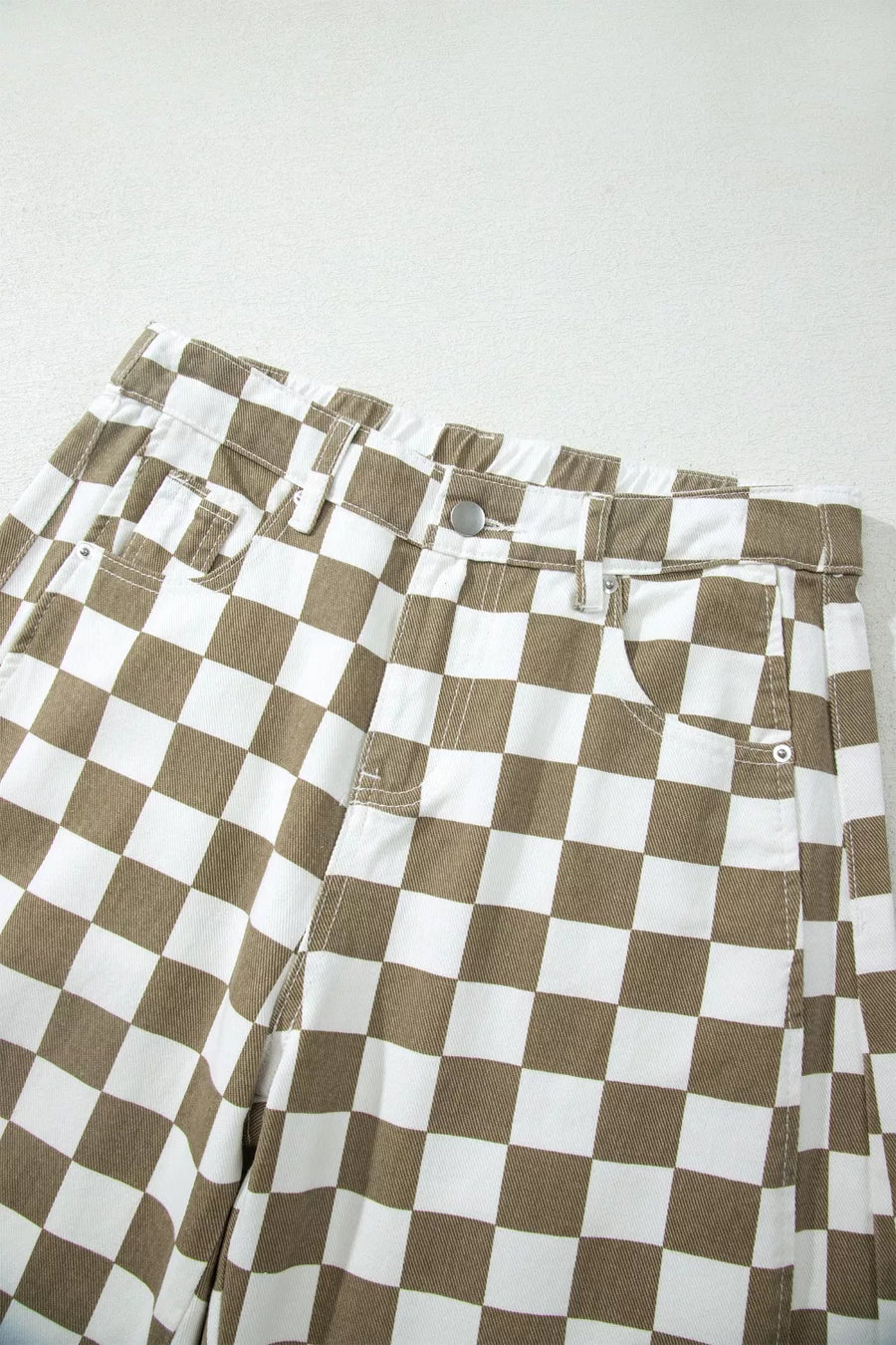 Chic checkered denim barrel pants in brown and white cotton with a button fly and pockets.