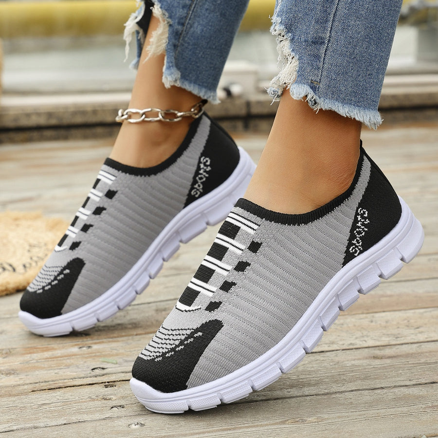 Mesh slip-on sneakers in gray and black with white soles and "SPORTS" detail.
