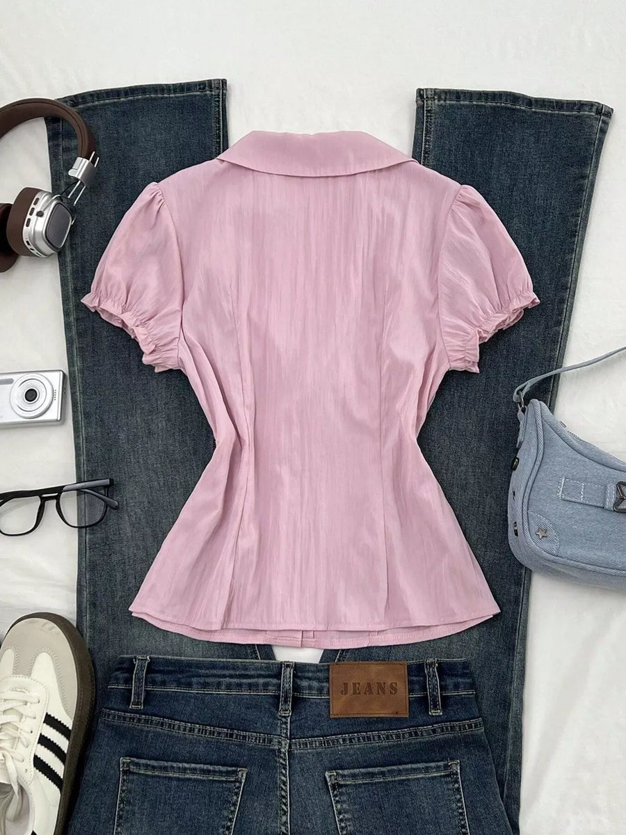 95% polyester, 5% spandex Care instructions: Machine wash cold button-up shirt in light pink with fitted silhouette