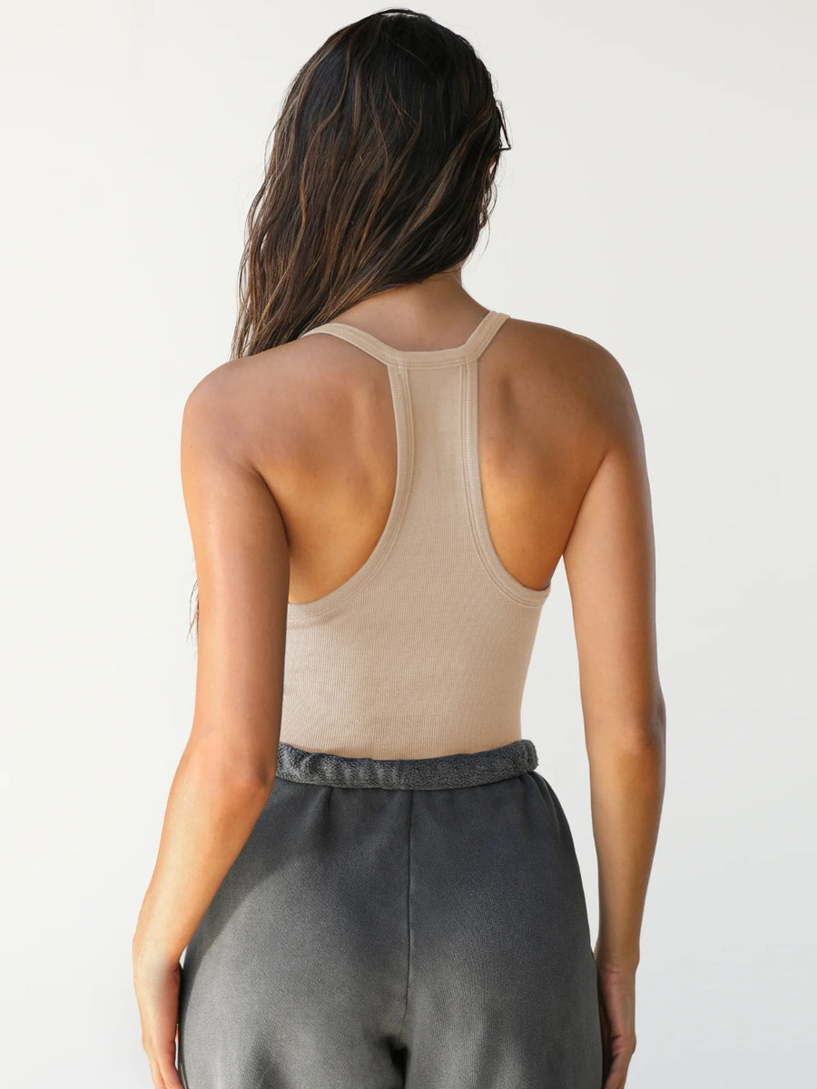 Tan ribbed racerback tank top with a deep scoop neckline, shown from the back.