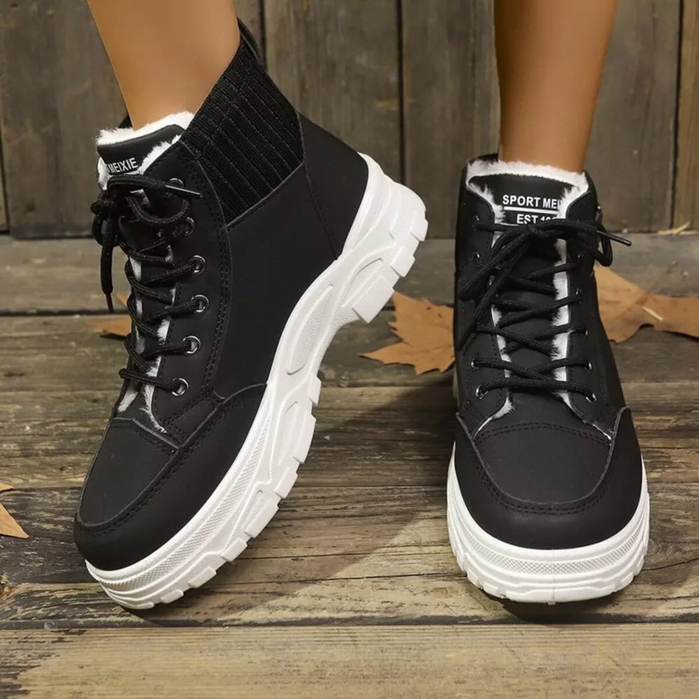 Black lace-up boots with plush white accents and a chunky white sole.