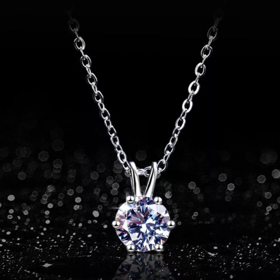 Elegant moissanite pendant necklace in sterling silver with a delicate chain.