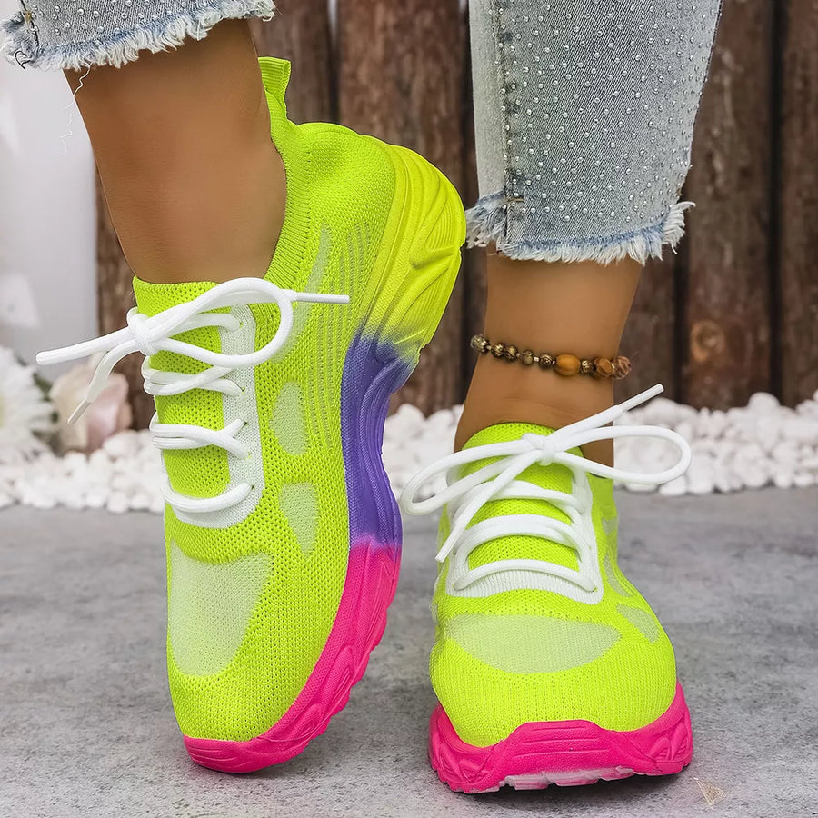 Breathable mesh lace-up sneakers in neon yellow with pink and purple sole detail.
