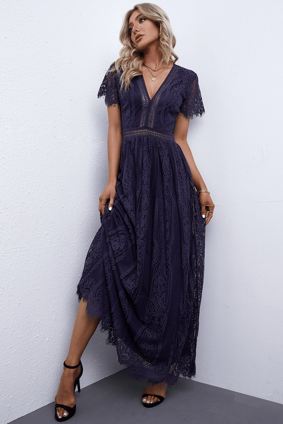 Navy lace midi dress with V-neck, flutter sleeves, and scalloped hem.