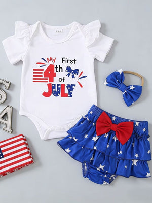 White baby bodysuit with ruffle sleeves and "My First 4th of July" graphic, blue star tiered skirt with red bow, and