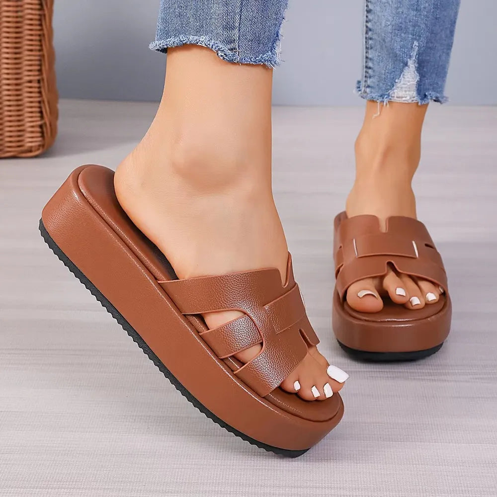 Platform caged leather slides in Terracotta with a thick sole.