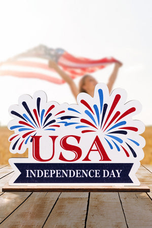 Patriotic Americana wooden tabletop decor with USA Independence Day text and fireworks design.