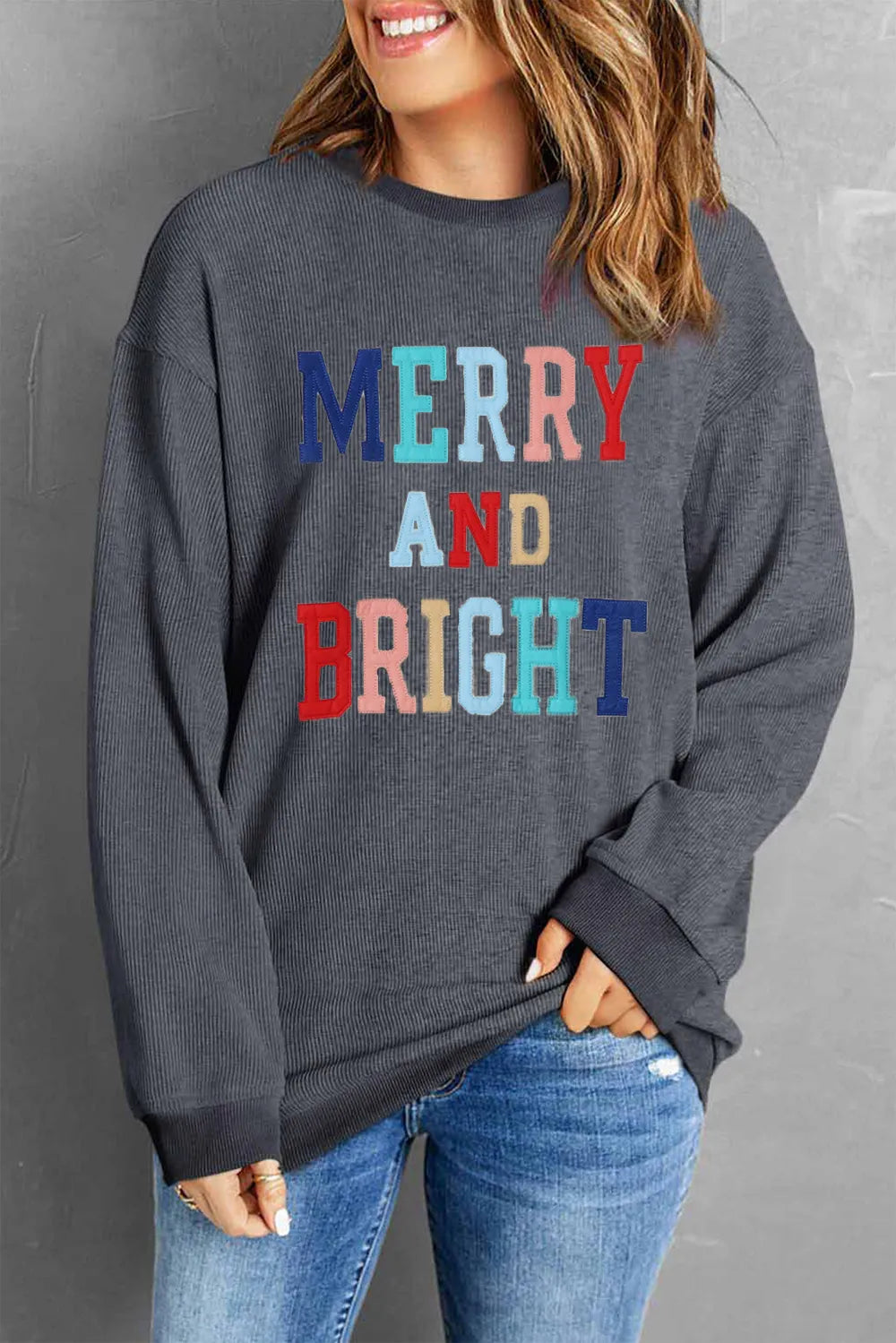 Dark Gray ribbed sweatshirt with "Merry and Bright" embroidered text in colorful letters.