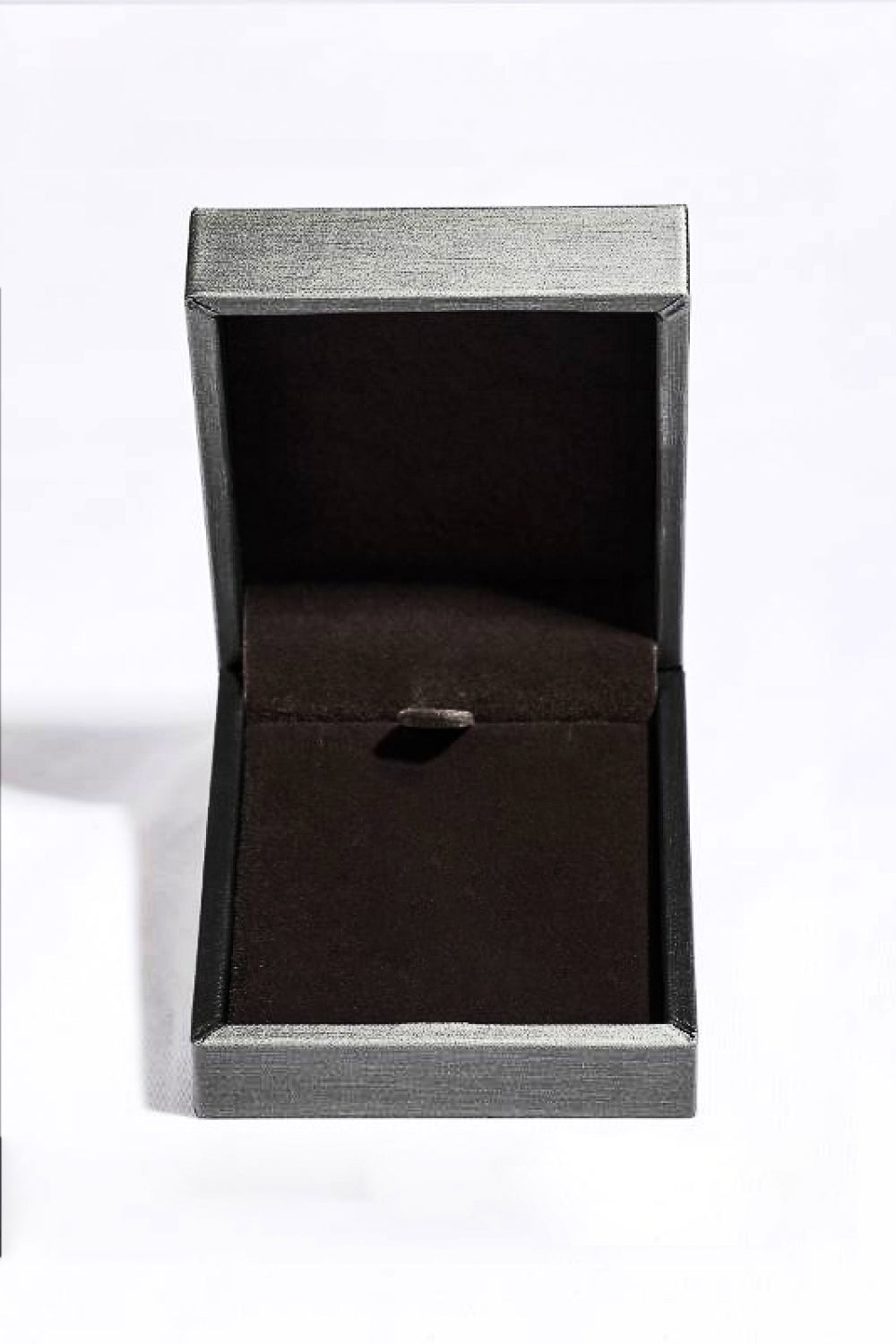 Silver jewelry box with dark interior and clasp.