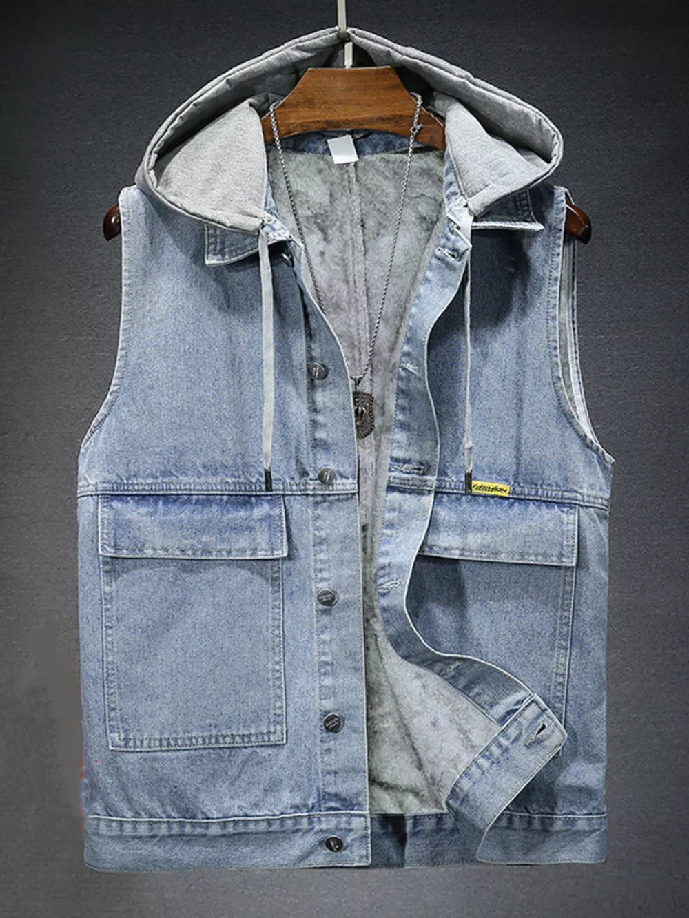 Light wash denim hooded vest with fleece lining and button-down front.