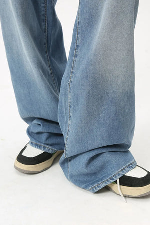 Oversized baggy denim jeans in medium wash, showing relaxed fit and casual styling.