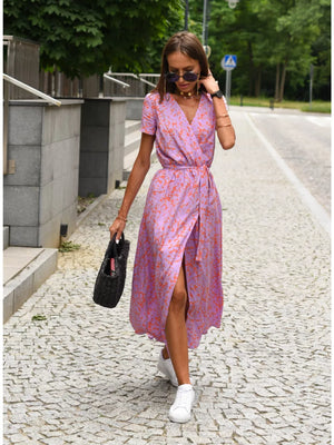 Wrap dress in lavender with orange floral print, short sleeves, V-neck, and tie waist.