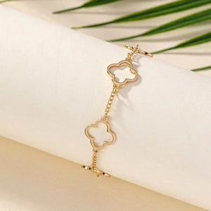 Gold four leaf clover charm bracelet with toggle clasp