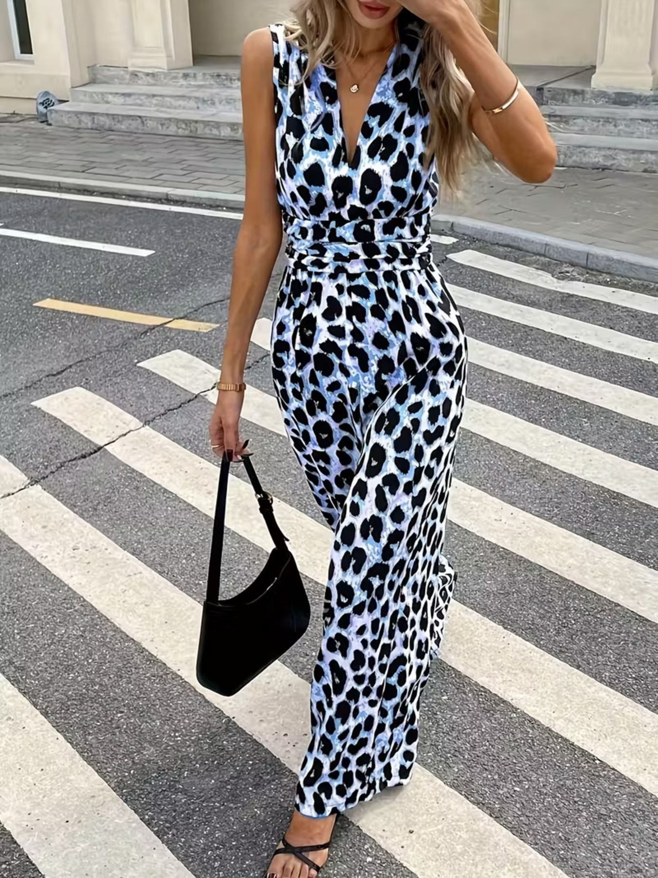 Sleeveless leopard print romper with V-neck and belted waist.