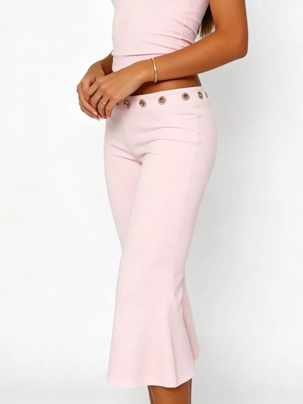 Pink maternity capri pants with flared hem and button detail at the waist.