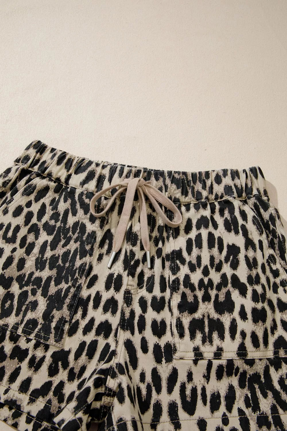 Denim shorts with leopard print and a lace-up drawstring waist.