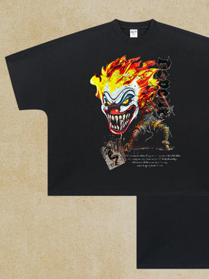 Black oversized t-shirt with a graphic of a flaming clown face and a figure.
