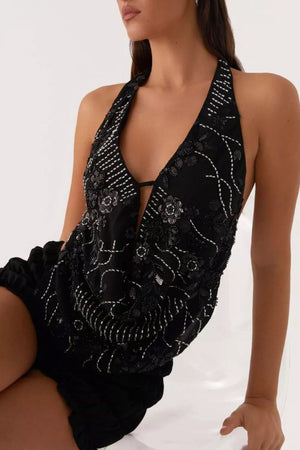 Black halter top with plunging neckline, floral bead and sequin embellishments, and tie detail.