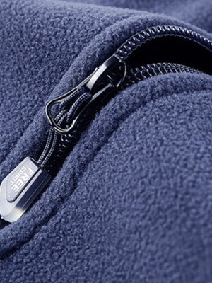Blue fleece quarter zip sweatshirt detail with zipper pull showing Free Spirit text