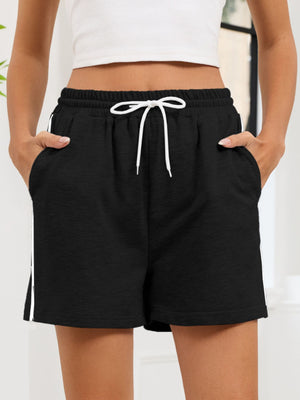 Black heathered jogger shorts with white drawstring and sporty side trim.